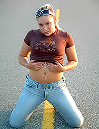 Sexy girlie is mad about the idea of posing in the road where everybody could see her